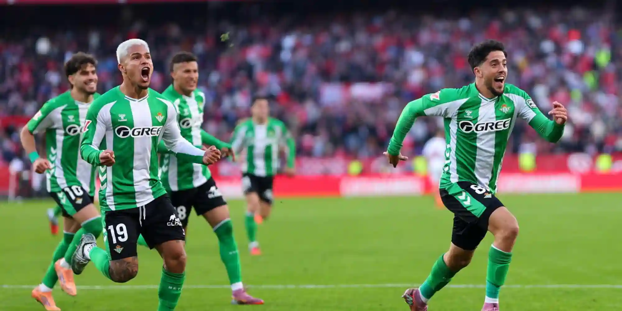 Betis players celebrate after scoring in the derby against Sevilla