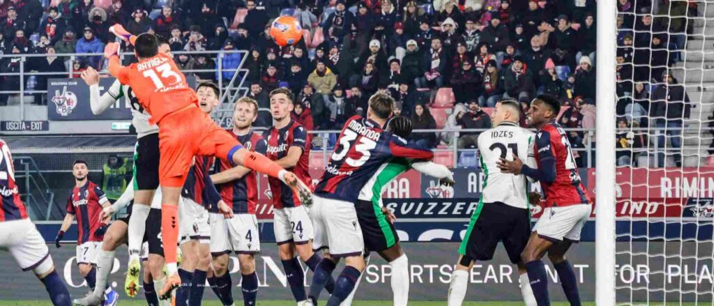 Bologna and Sassuolo players jumping for a high ball