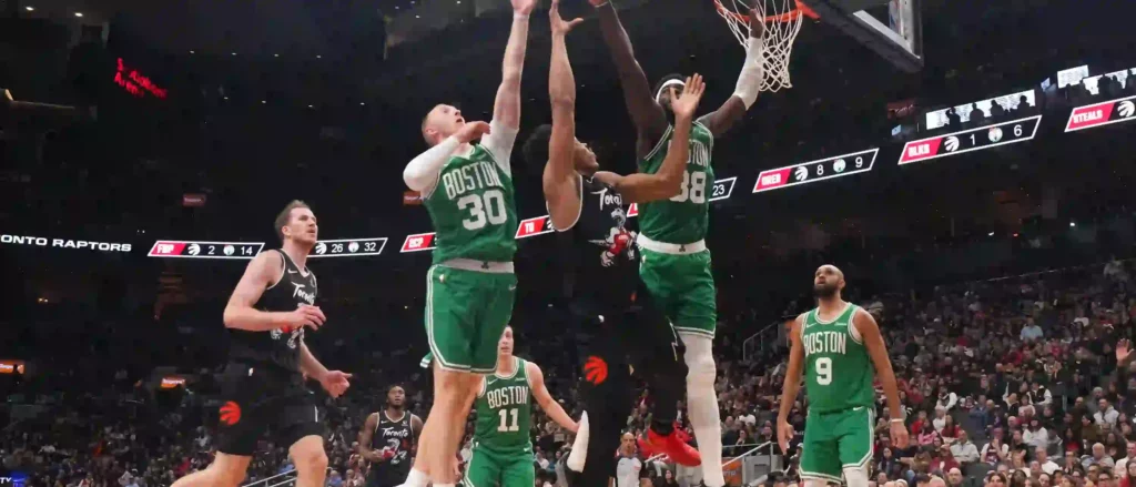 Boston and Toronto players battling for a rebounded ball