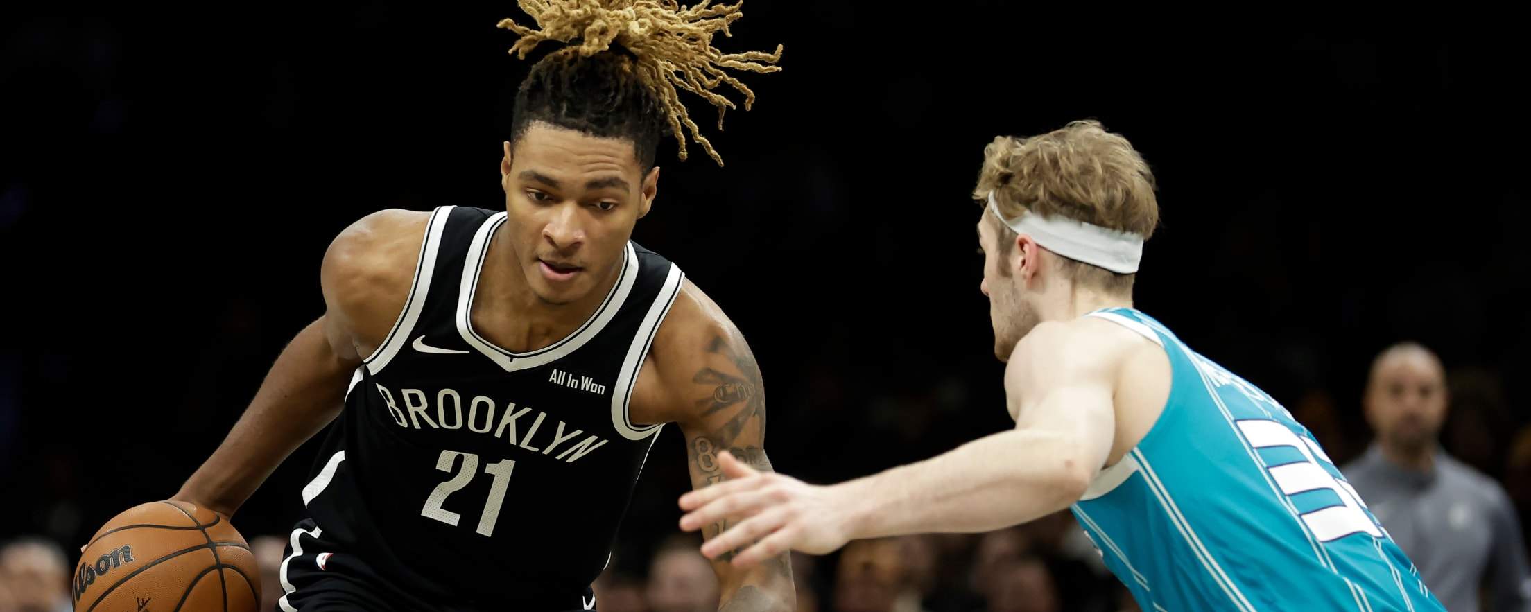 Noah Clowney guarded by a Charlotte Hornets player