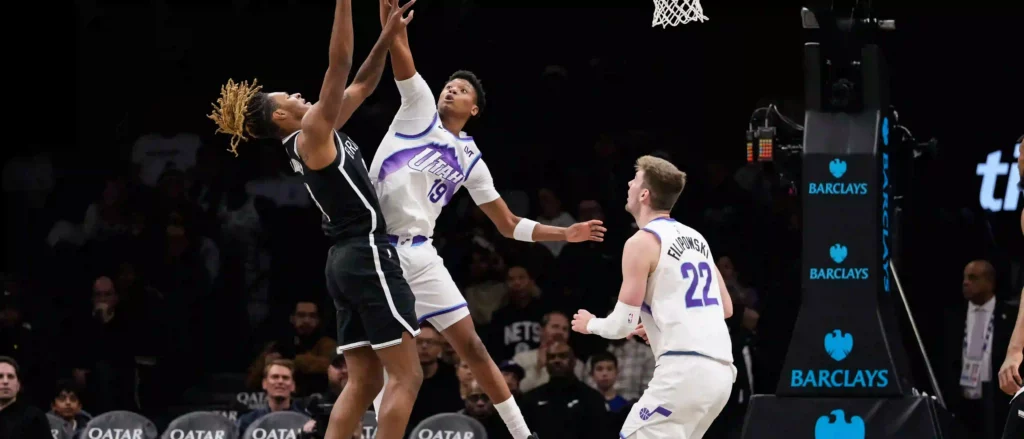 Utah Jazz player blocking a Brooklyn Nets opponent