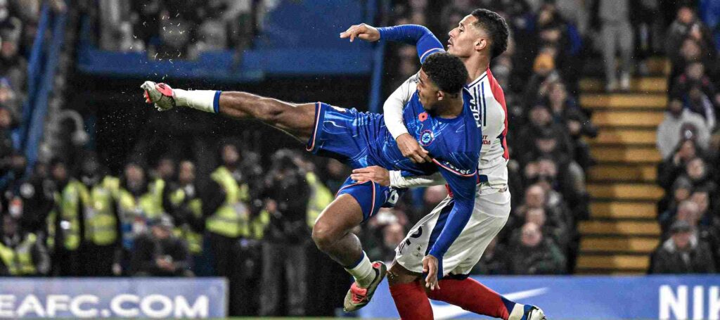 Arsenal player lifting Chelsea player in the air