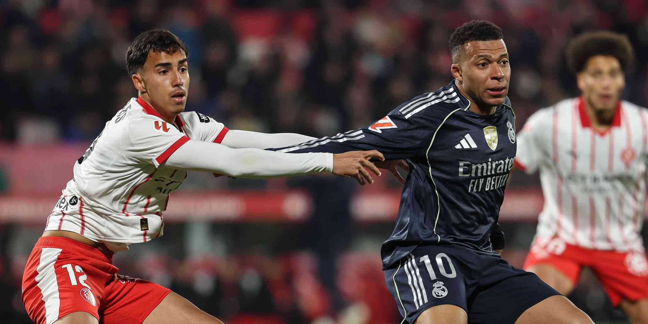 Girona player guarding Kylian Mbappe