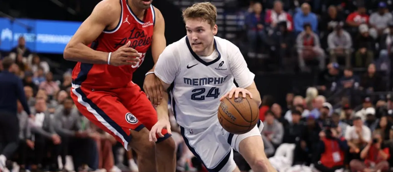 Cam Spencer dribbles the ball guarded by a Los Angeles Clippers player
