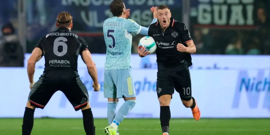 Cremonese striker Jamie Vardy holding the ball after scoring a goal