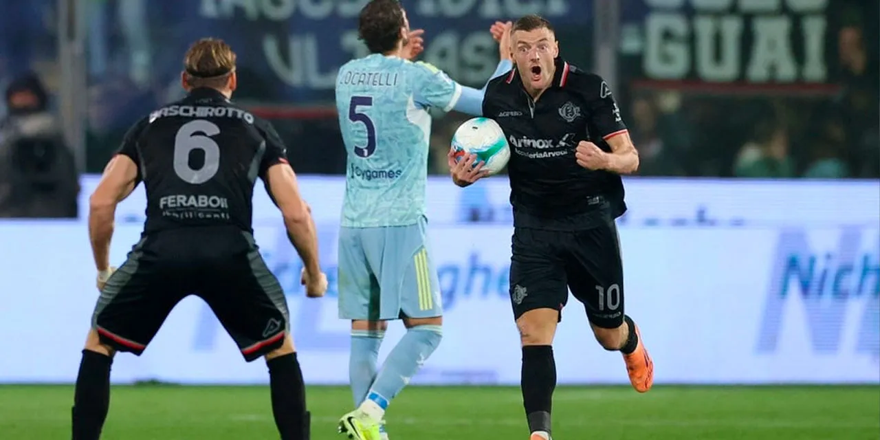 Cremonese striker Jamie Vardy holding the ball after scoring a goal