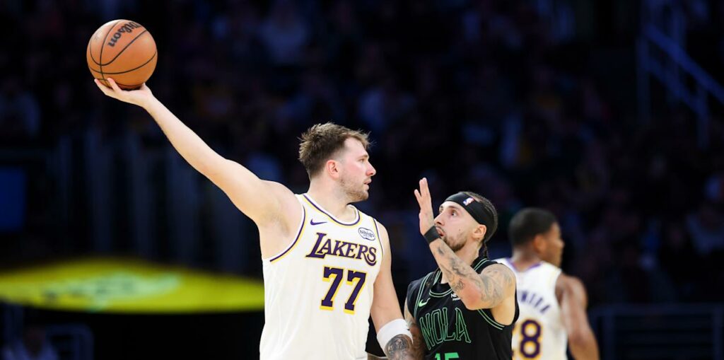 Luka Doncic protecting the ball from a New Orleans Pelicans player