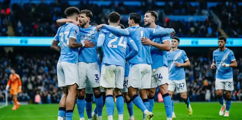 Manchester City players celebrate after scoring against Brentford