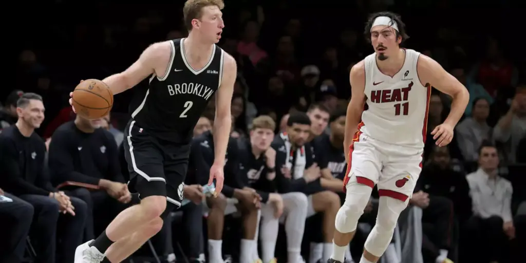 Danny Wolf dribbles the ball guarded by Jaime Jaquez Junior