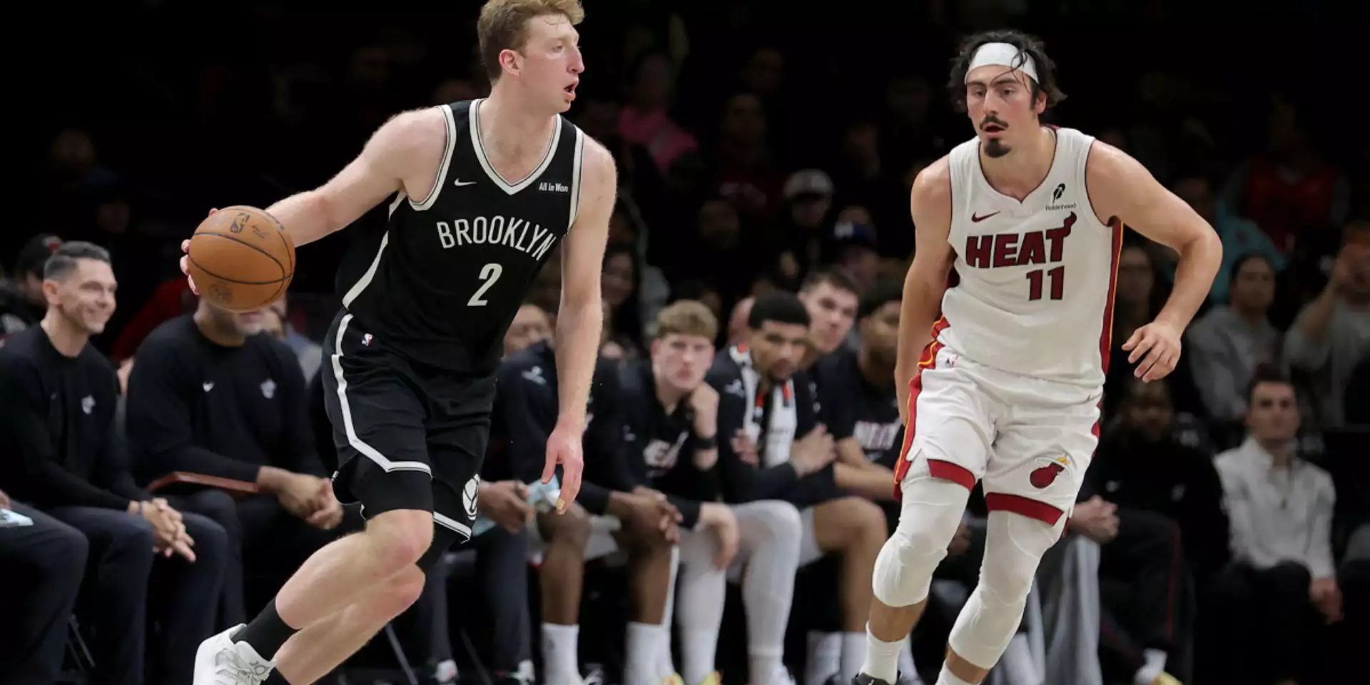 Danny Wolf dribbles the ball guarded by Jaime Jaquez Junior