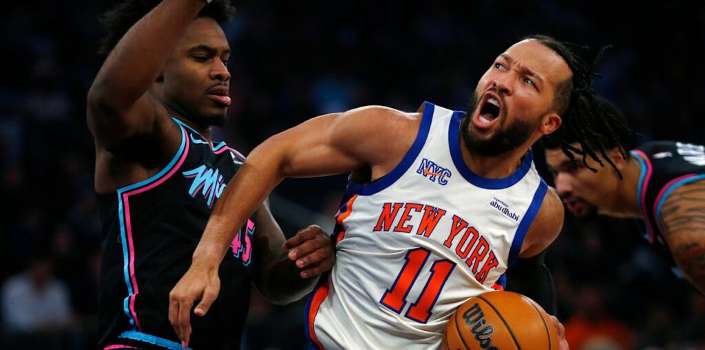 Jalen Brunson guarded by multiple Miami Heat players