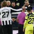Newcastle and Tottenham players watching VAR replay behind the referee