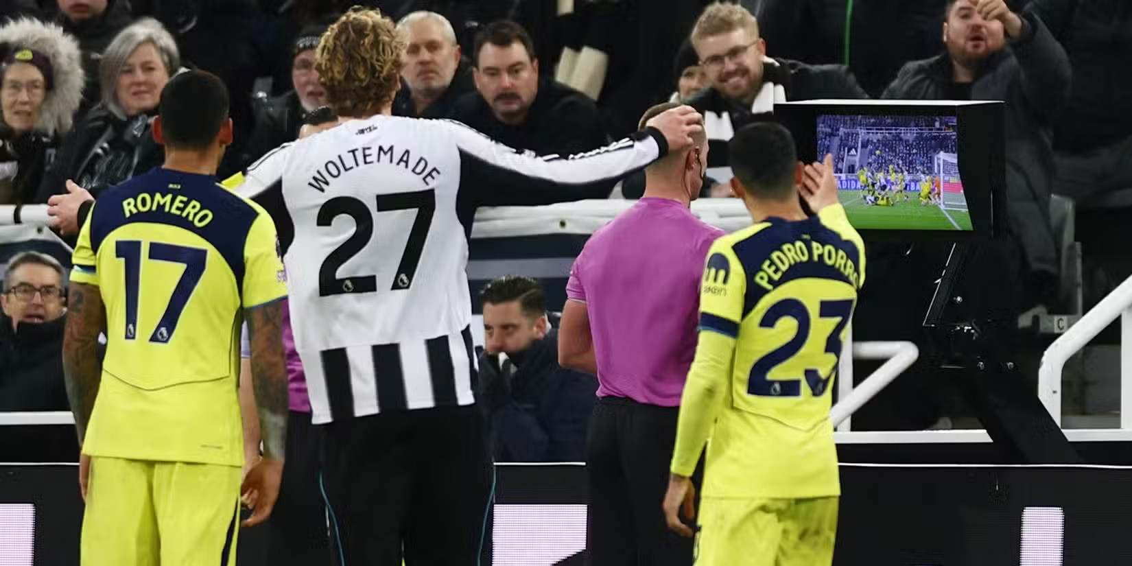 Newcastle and Tottenham players watching VAR replay behind the referee