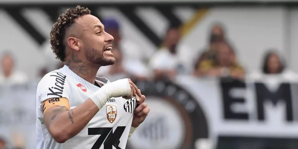 Neymar Jr. pointing to Santos' badge