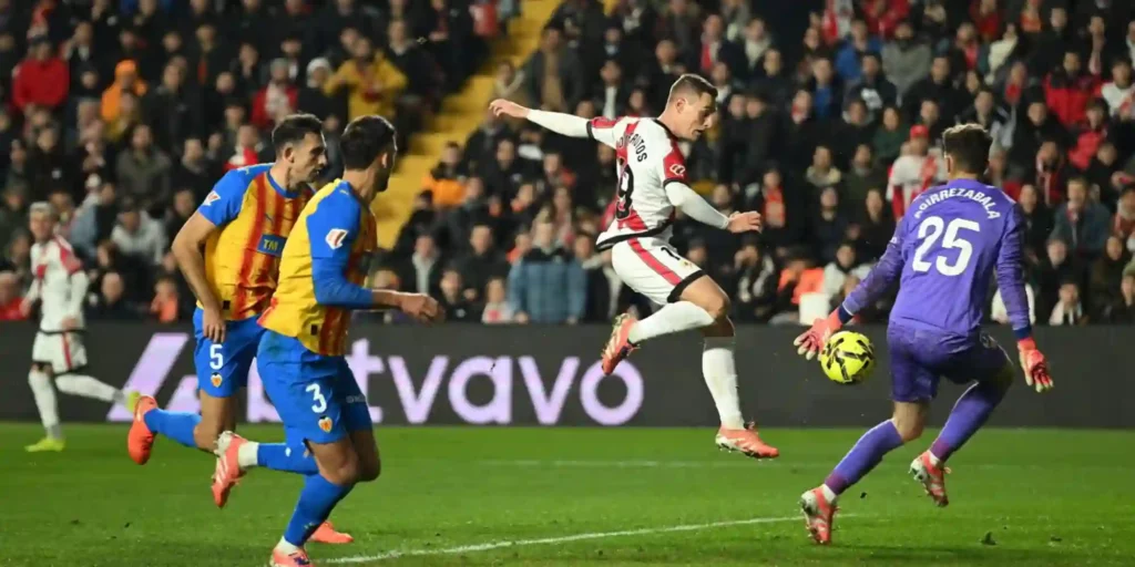 Rayo Vallecano player shooting at Valencia's goal