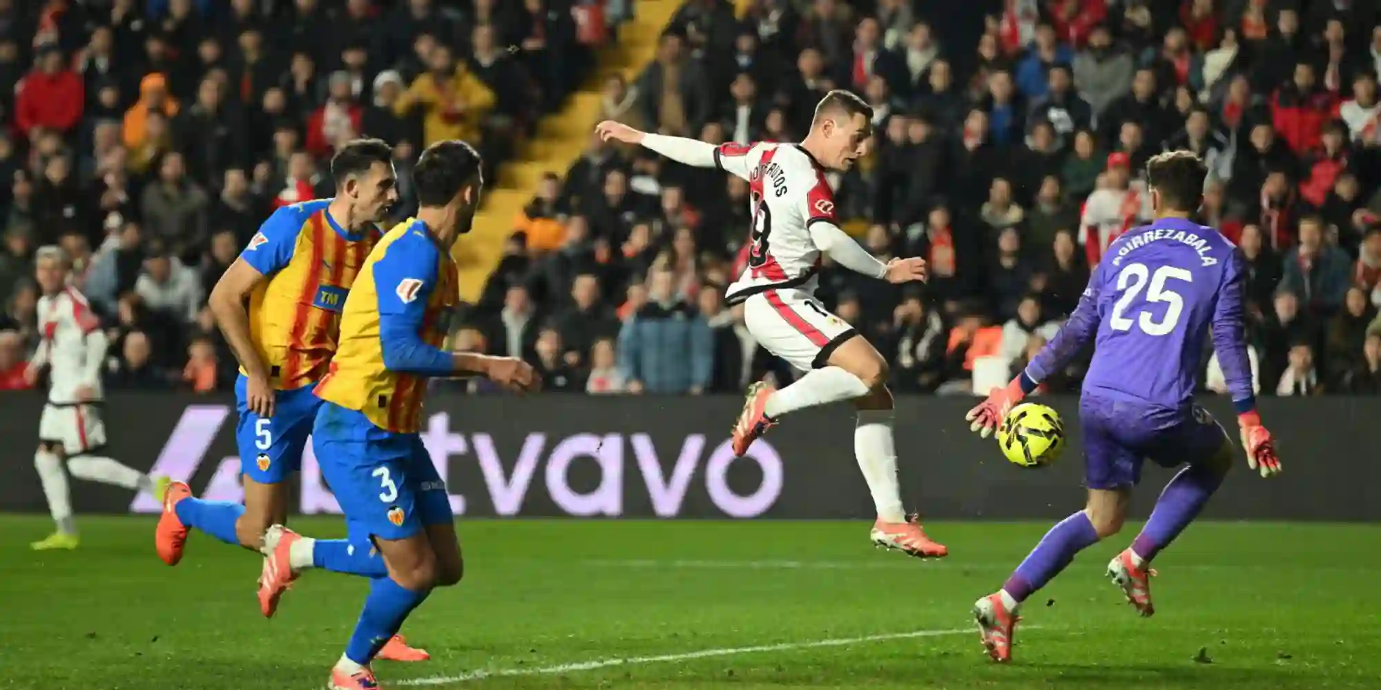 Rayo Vallecano player shooting at Valencia's goal