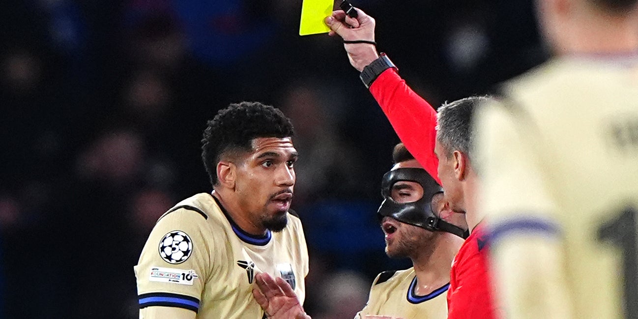 Barcelona defender Ronald Araujo being shown a yellow card