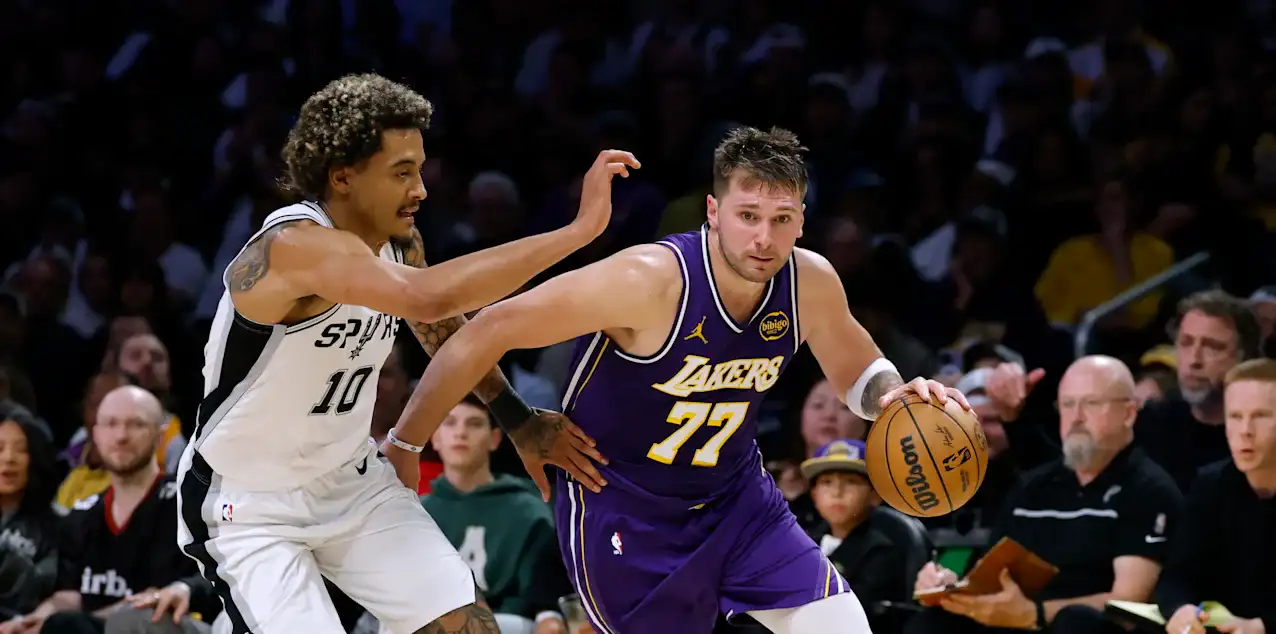 Jeremy Sochan trying to stop Luka Doncic