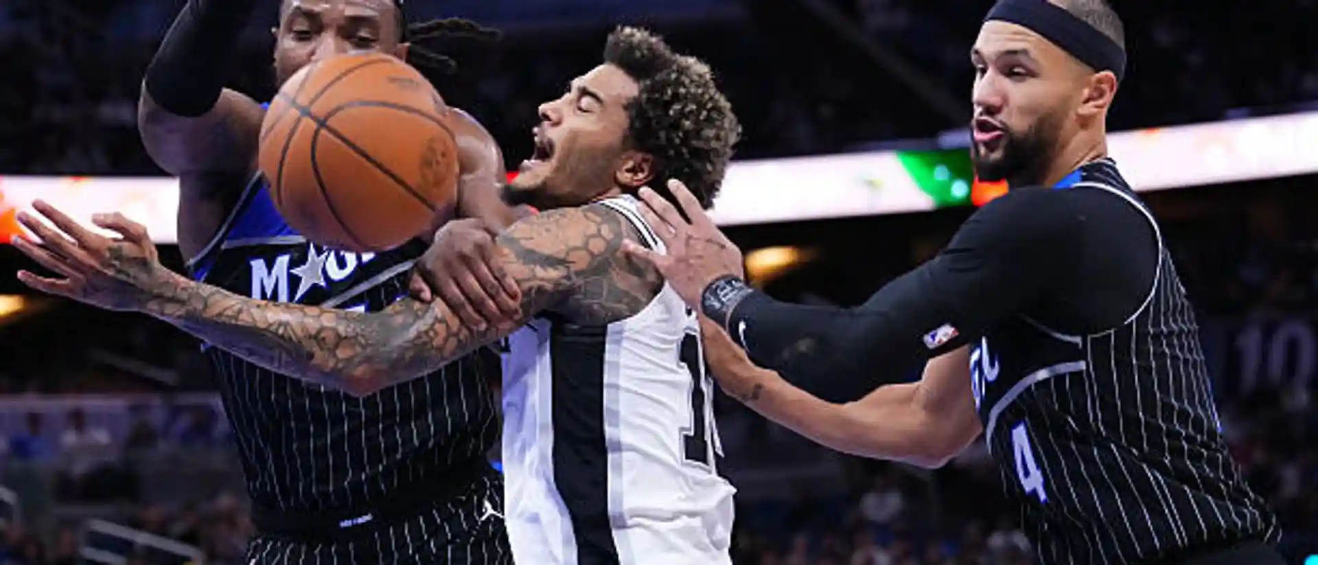 Orlando Magic and San Antonio players battle for the ball