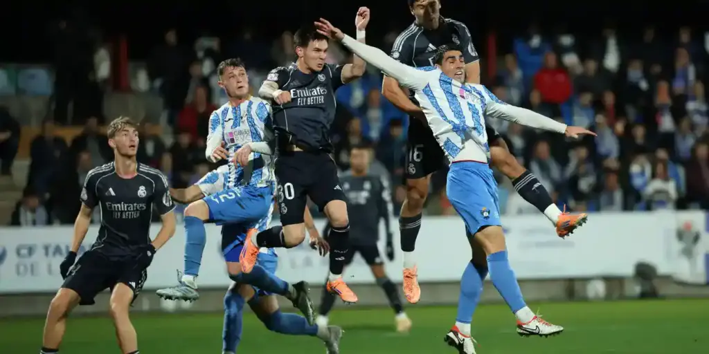 Players of Talavera and Real Madrid jumping for a high ball