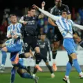 Players of Talavera and Real Madrid jumping for a high ball
