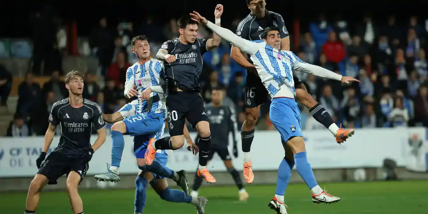 Players of Talavera and Real Madrid jumping for a high ball