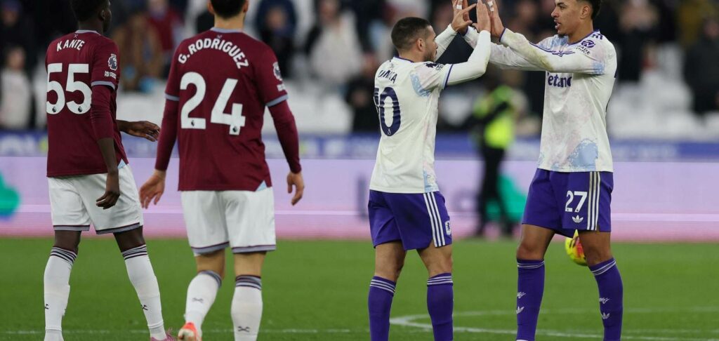 Aston Villa players congratulate one another after scoring against West Ham