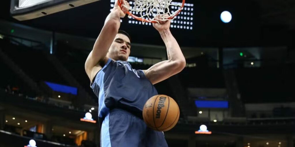 Memphis Grizzlies center Zach Edey dunking the ball