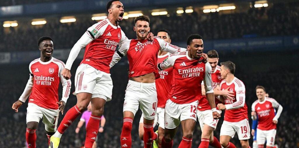 Arsenal players celebrate after scoring against Chelsea