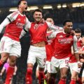 Arsenal players celebrate after scoring against Chelsea