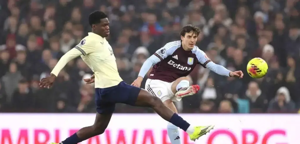 Aston Villa player crosses the ball during the match against Everton