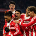 Bayern Munich players congratulate Michael Olise after scoring against Wolfsburg