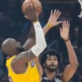 LeBron James trying to score in Cleveland's basket despite Jarrett Allen's defence