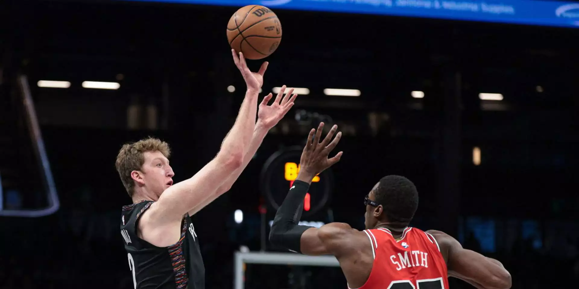 Danny Wolf shoots over Jalen Smith