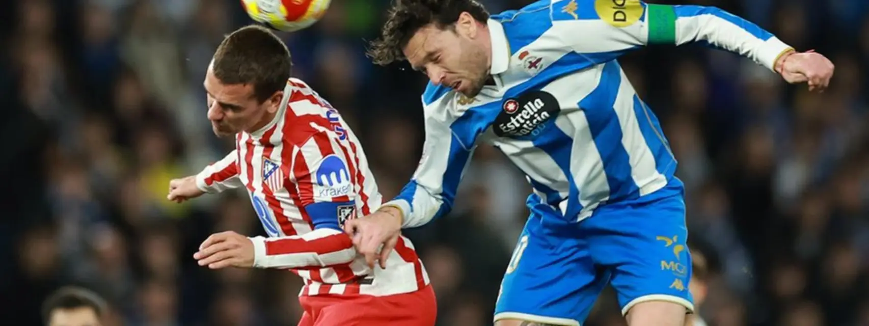 Deportivo la Coruna player in a battle for a high ball with Antoine Griezmann