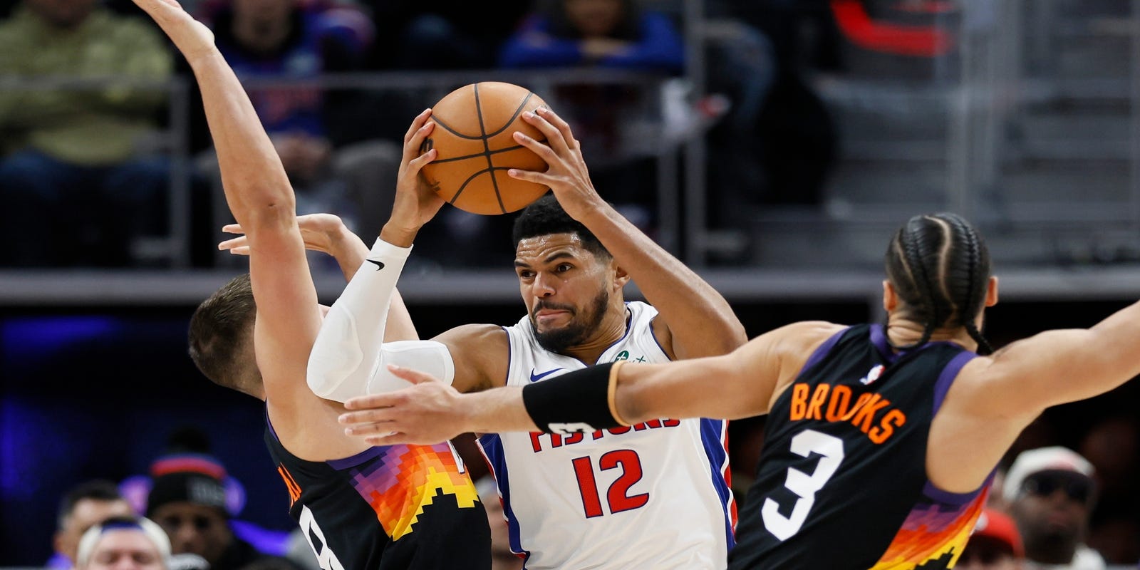 Tobias Harris guarded by multiple Phoenix Suns players