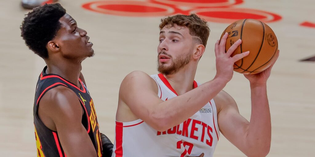 Alperen Sengun protecting the ball from an Atlanta Hawks player