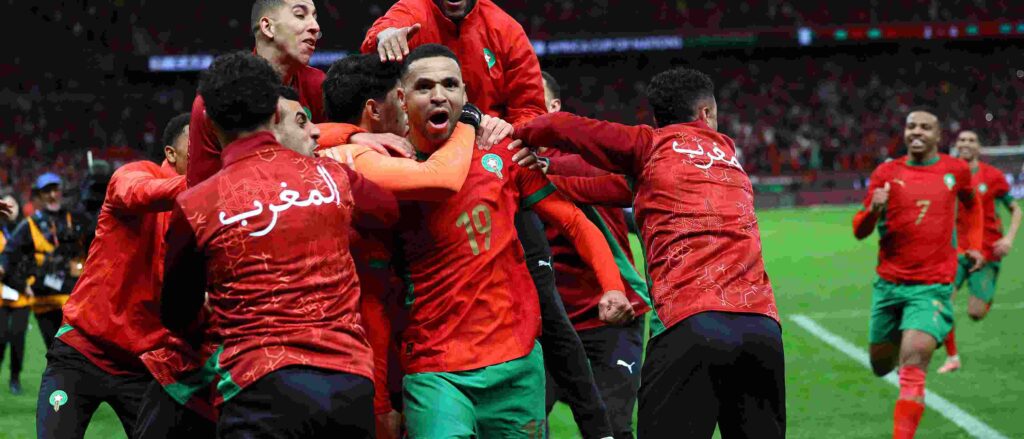 Morocco players celebrate after eliminating Nigeria on penalties