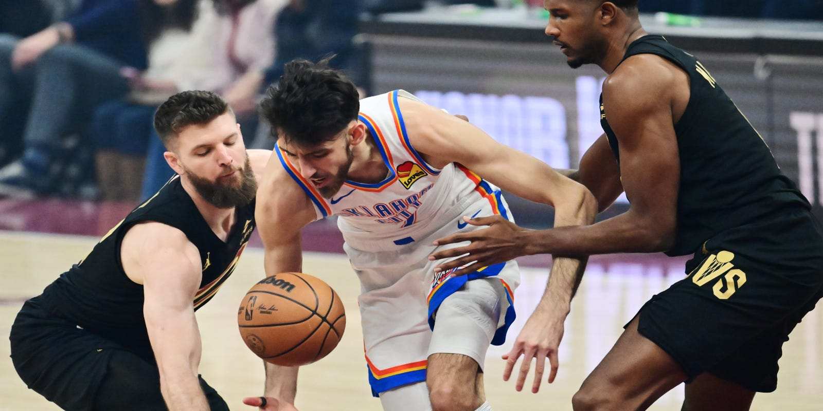 Chet Holmgren in a battle for the ball with 2 Cleveland players
