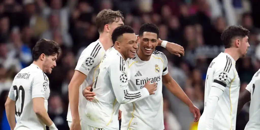 Kylian Mbappe and Jude Bellingham hugging each other after Real Madrid have scored against Monaco