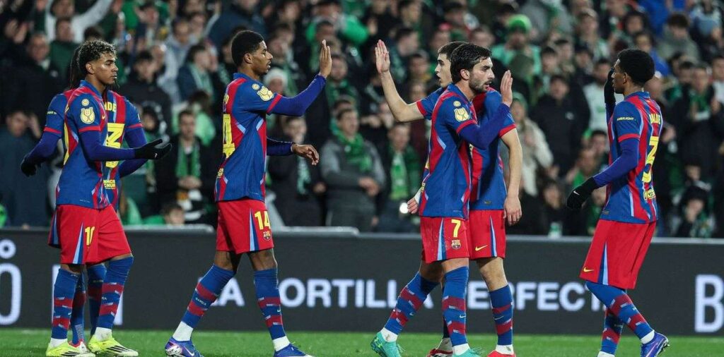 Barcelona players congratulate each other after scoring against Racing Santander
