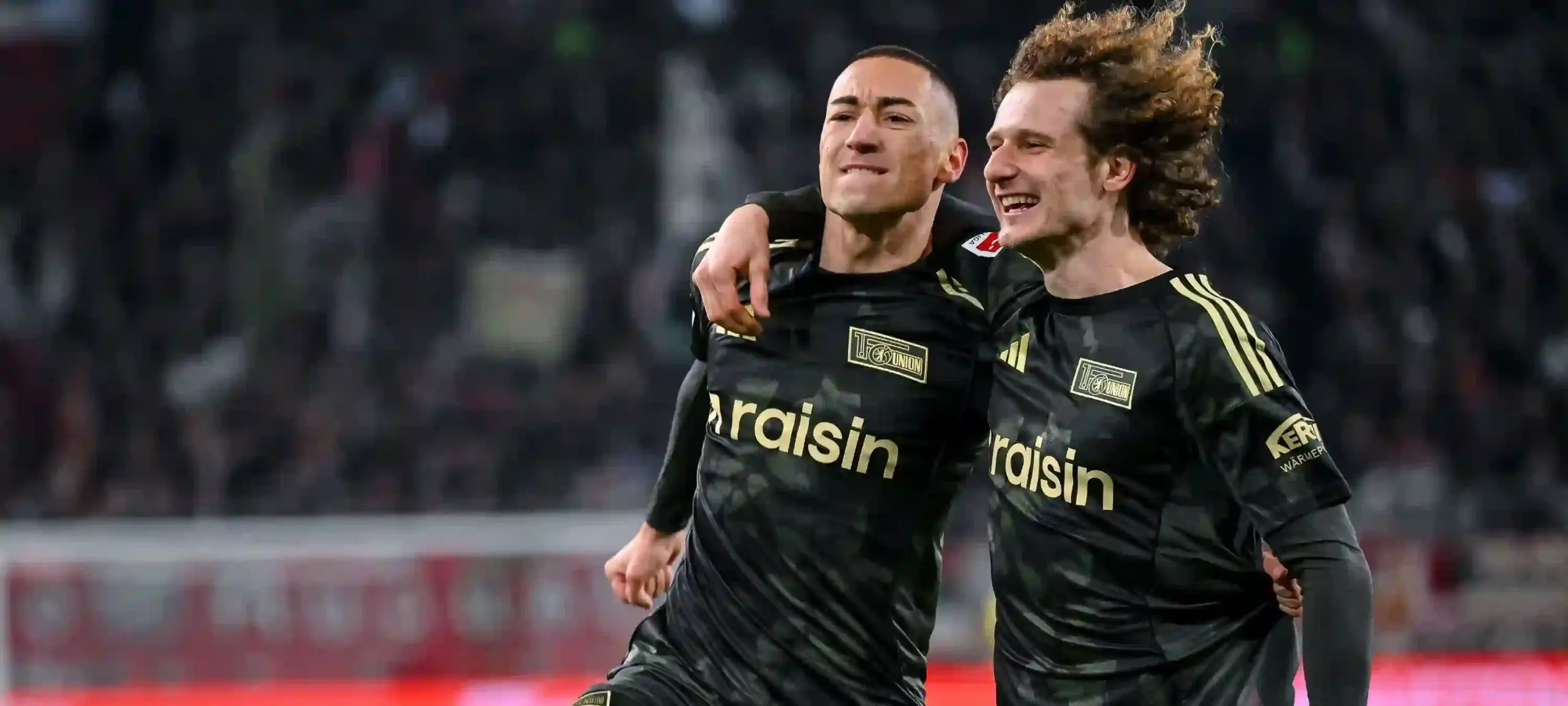 Union Berlin players celebrate after equalising against Augsburg