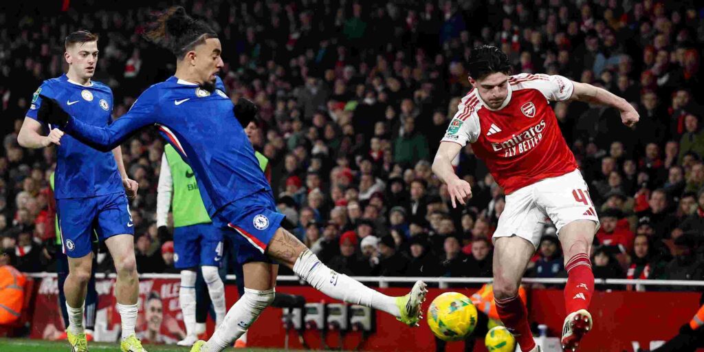 Malo Gusto trying to prevent Delcan Rice from crossing the ball