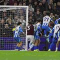 Aston Villa and Brighton players jumping for a high ball