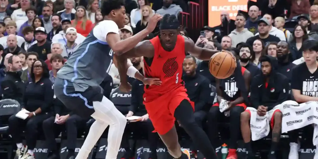 Jrue Holiday dribbling past Utah Jazz defender