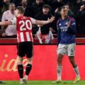 Brentford and Arsenal players talking to the referee