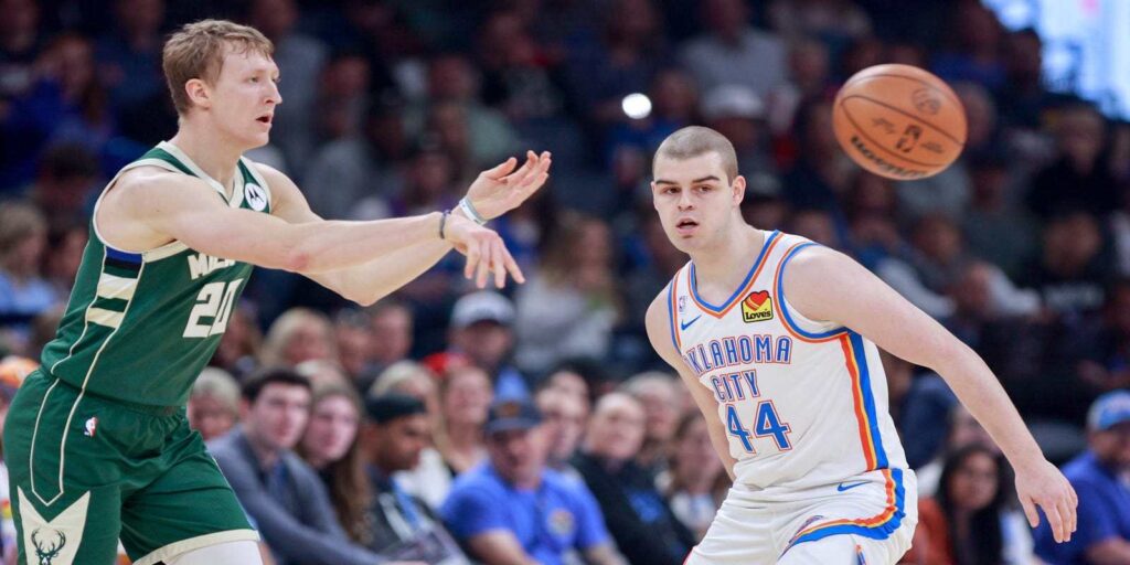 AJ Green passes the ball, guarded by Nikola Topic