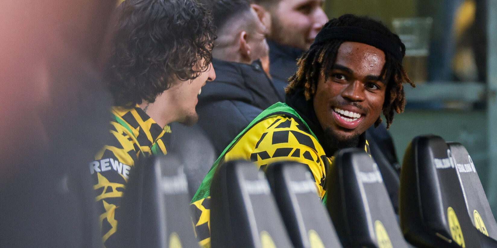 Carney Chukwuemeka smiling from Borussia Dortmund's bench