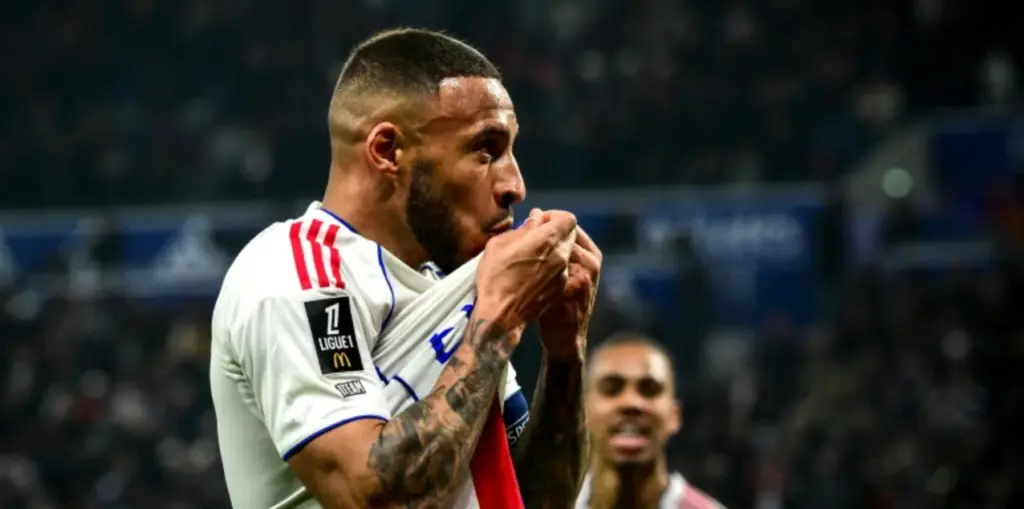 Lyon midfielder Corentin Tolisso kissing the badge on his shirt after scoring against Nice