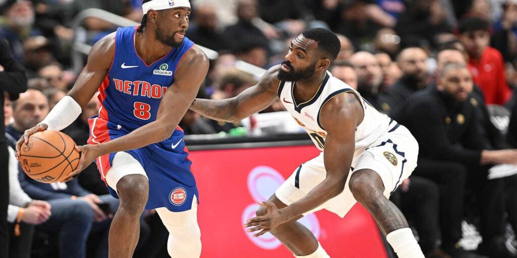 Caris LeVert guarded by Denver Nuggets player